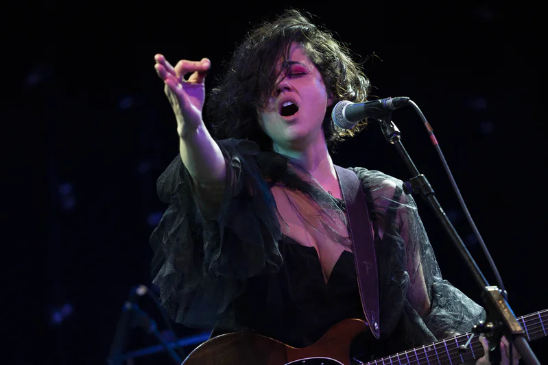 JER performing live, one arm raised while singing